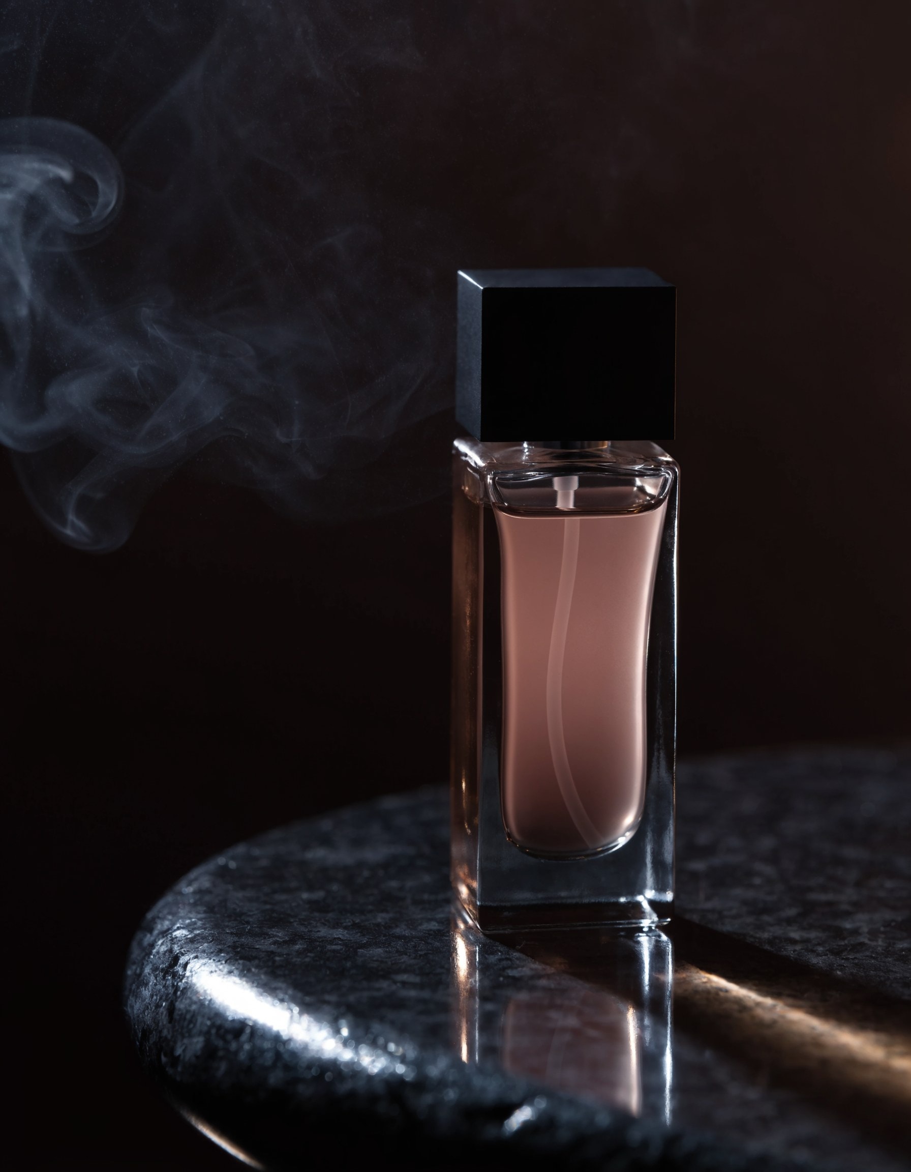 CENDRE Eau de Parfum — sculpted flacon of dusky rose-grey scent, a wisp of smoke beside it on dark stone.