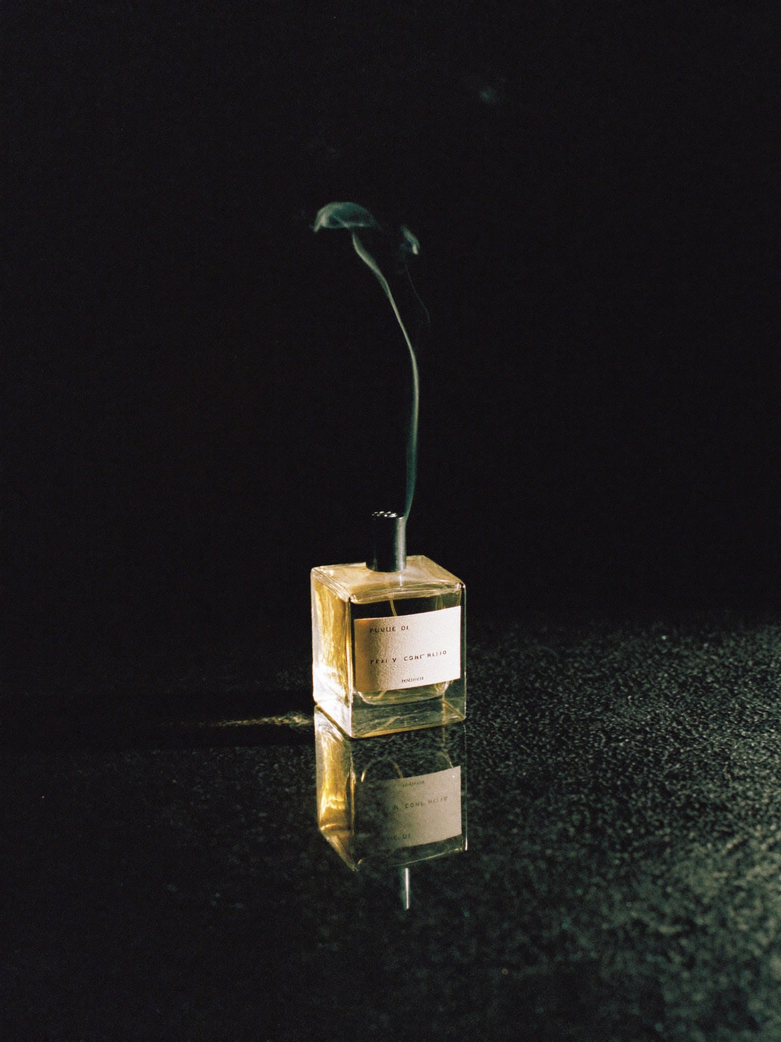 SÉVE Eau de Parfum — the 100ml atelier flacon, clear glass on wet black stone.